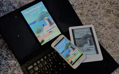 Un ordinateur portable, un smartphone et un **kindle audio** affichent un guide numérique sur le Monténégro et Dubrovnik.